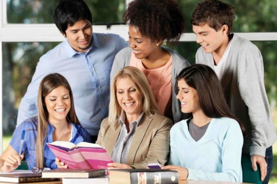 A group of students reading a book together